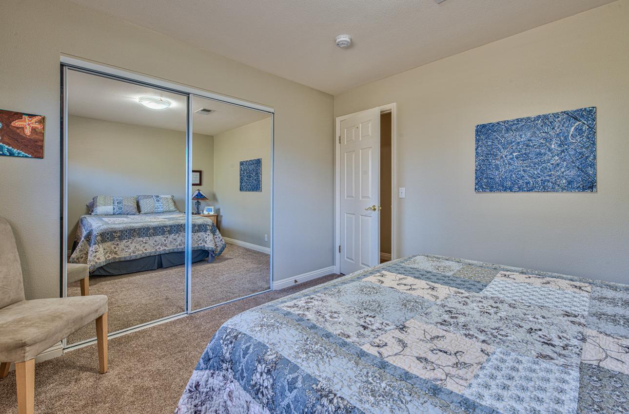 18401 Moro Road Salinas, CA 93907 - Photo 27 of 39 a bedroom with a bed and a large mirror