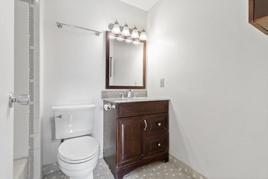 1006 Paradise Road, Unit 1A Swampscott, MA 01907 - Photo 10 of 18 a bathroom with a toilet a sink and mirror
