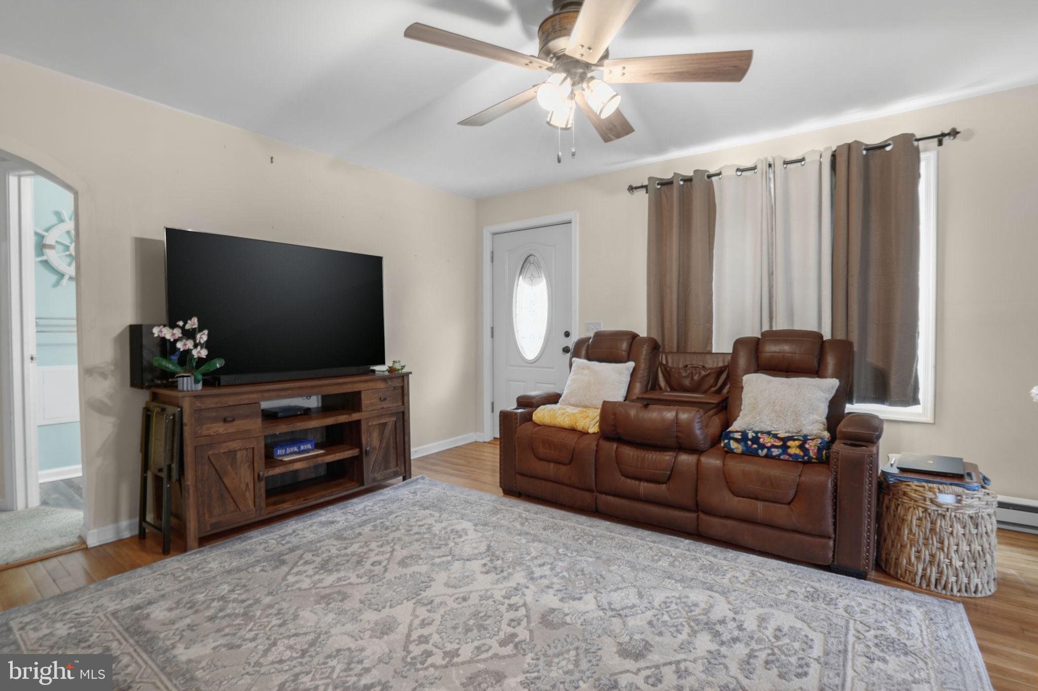 7278 Fleming Road New Church, VA 23415 - Photo 8 of 44 a living room with furniture and a flat screen tv