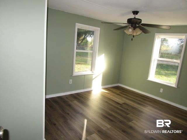 14791 Raber Road Summerdale, AL 36580 - Photo 15 of 21 Unfurnished room with ceiling fan and dark hardwood / wood-style flooring