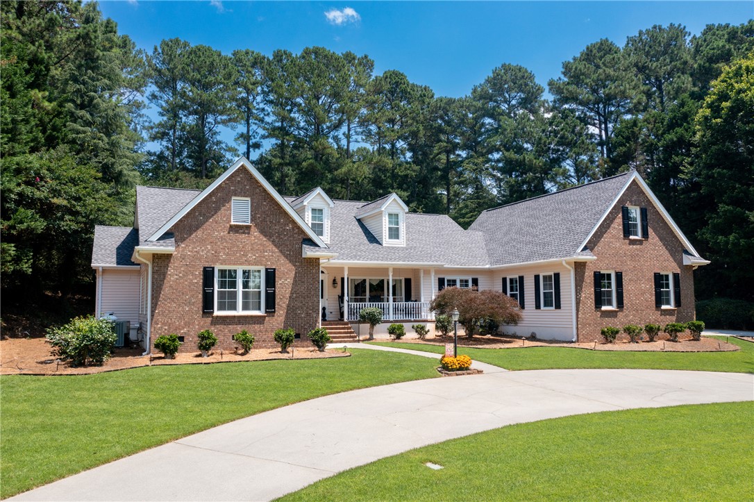 308 Amethyst Way Seneca, SC 29672 - Photo 2 of 49 A circular concrete driveway welcomes you to the classic vinyl brick exterior with black shutters