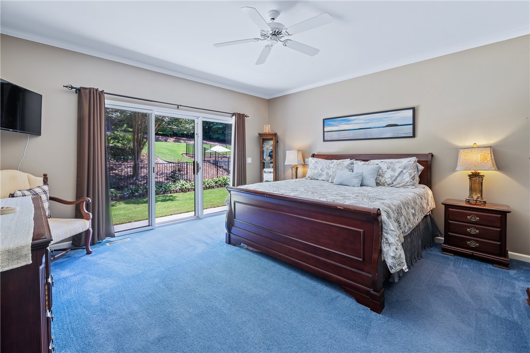 308 Amethyst Way Seneca, SC 29672 - Photo 22 of 49 The spacious primary suite, tucked privately to the left of the foyer, boasts a large walk-in closet, linen storage, ensuite bath with dual vanities, jetted tub, walk-in shower, and private pool patio access.