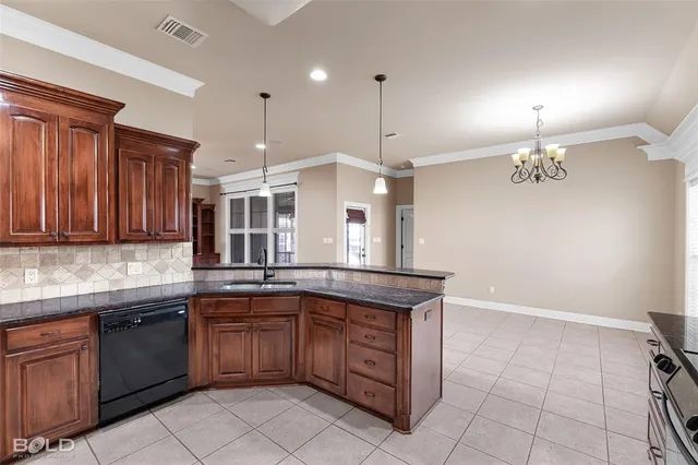 a kitchen with granite countertop a stove top oven and cabinets