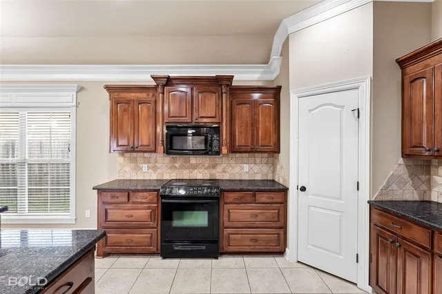 an empty room with fireplace and windows