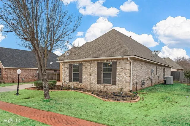 a front view of house with a garden