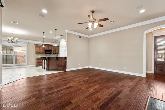 a view of an empty room with a fireplace and a window
