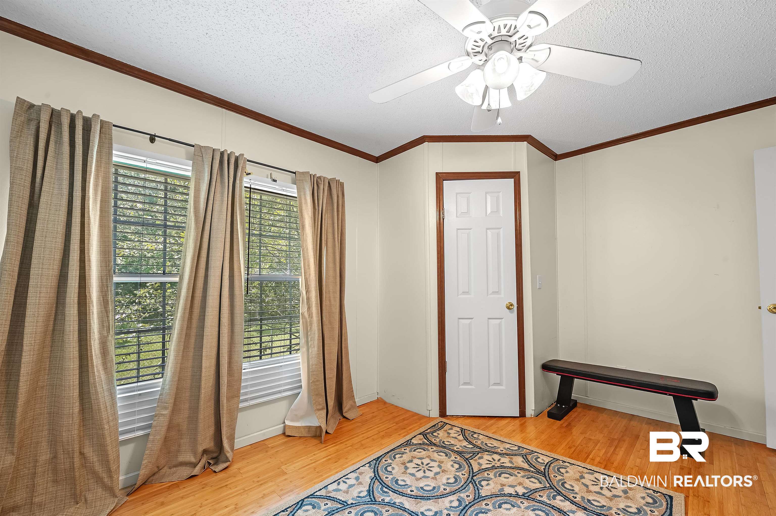 10970 Stucki Road Elberta, AL 36530 - Photo 33 of 56 Foyer with a textured ceiling, crown molding, Bamboo flooring, and ceiling fan