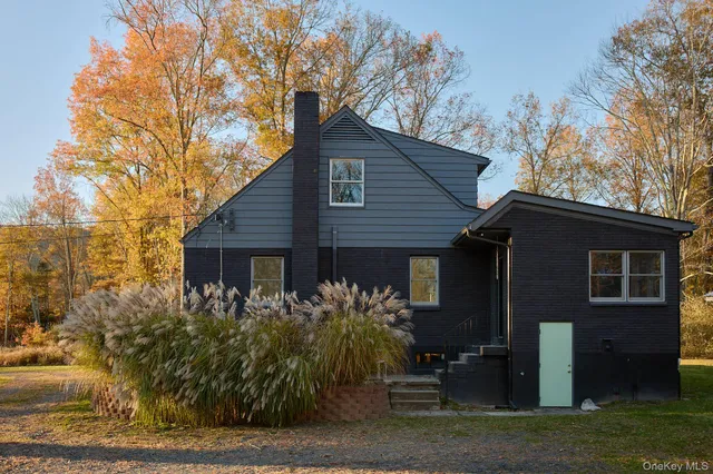 a house that has a tree in front of the house