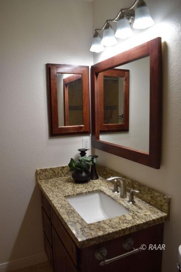 608 South Norma Street Ridgecrest, CA 93555 - Photo 10 of 21 a bathroom with a granite countertop sink and a mirror