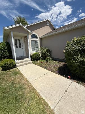 641 East Greystone Way Tooele, UT 84074 - Photo 2 of 30 Stucco exterior with an arched window and covered entryway
