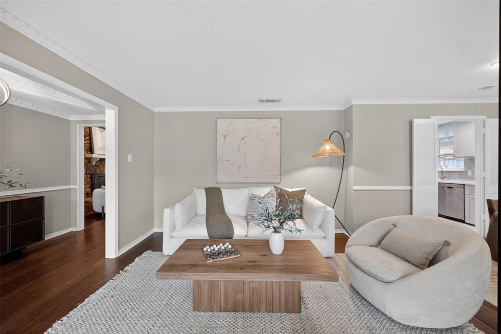 9660 Timberleaf Drive Dallas, TX 75243 - Photo 19 of 40 Spacious living area featuring rich wood-finish flooring, light gray wall tones, and white crown molding