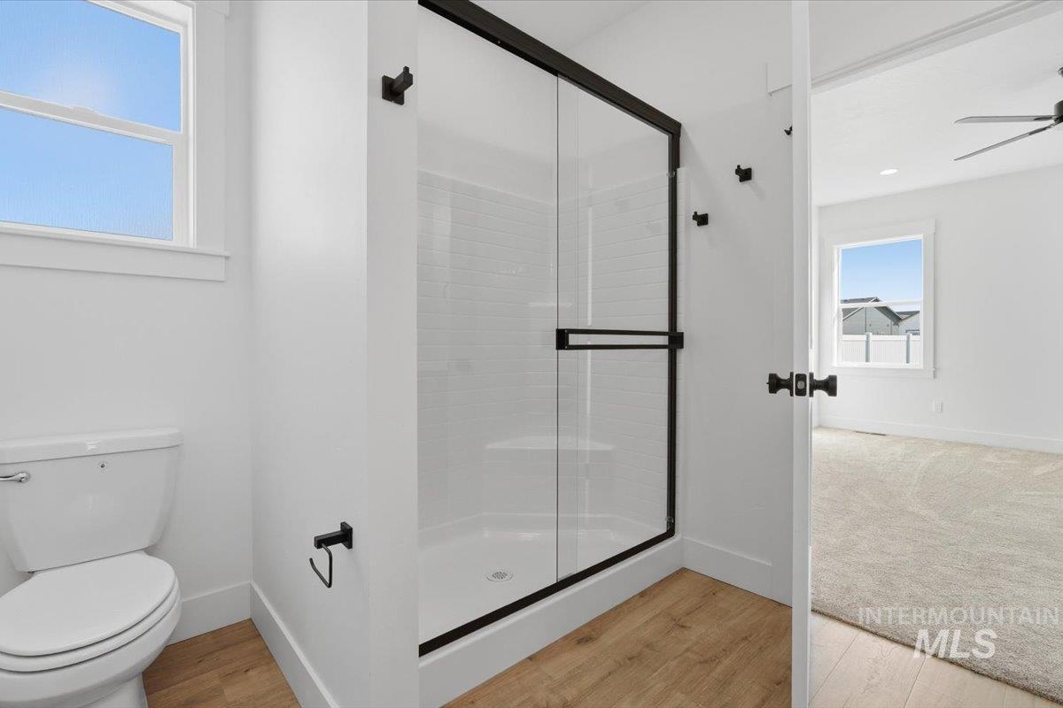 2175 Austin Way Fruitland, ID 83619 - Photo 24 of 30 Full bath with light wood finished floors, a shower stall, and ceiling fan