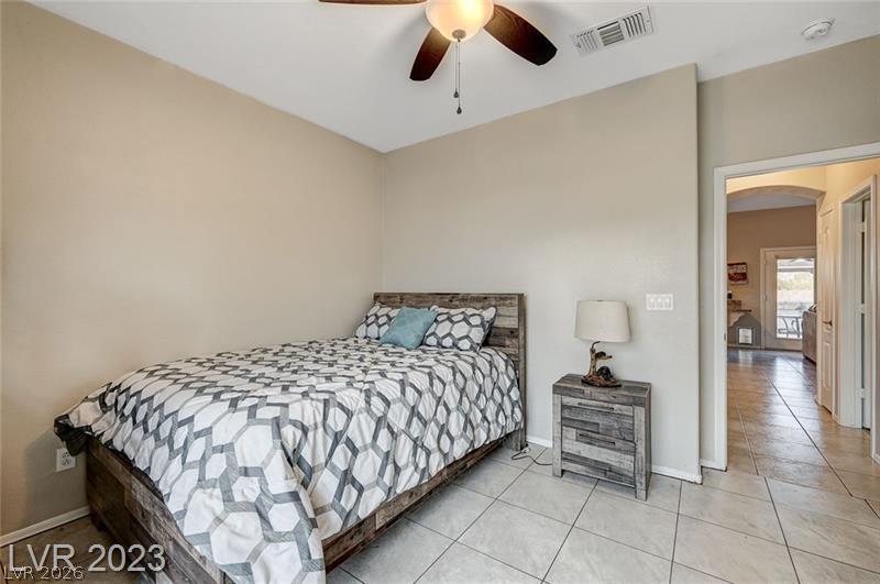 987 Cutter Street Henderson, NV 89011 - Photo 13 of 17 Comfortable sleeping quarters feature durable tile flooring and a ceiling fan for year-round comfort.