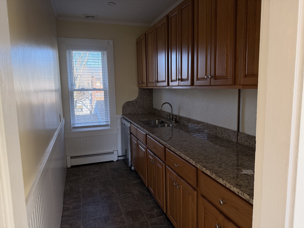 3-5 Milk Street, Unit 2 Methuen, MA 01844 - Photo 2 of 12 a kitchen with stainless steel appliances granite countertop a sink stove and cabinets