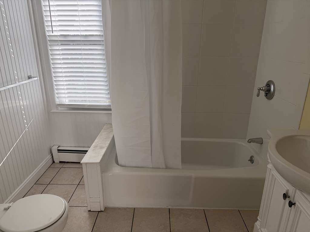 3-5 Milk Street, Unit 2 Methuen, MA 01844 - Photo 4 of 12 a bathroom with a toilet and a bathtub