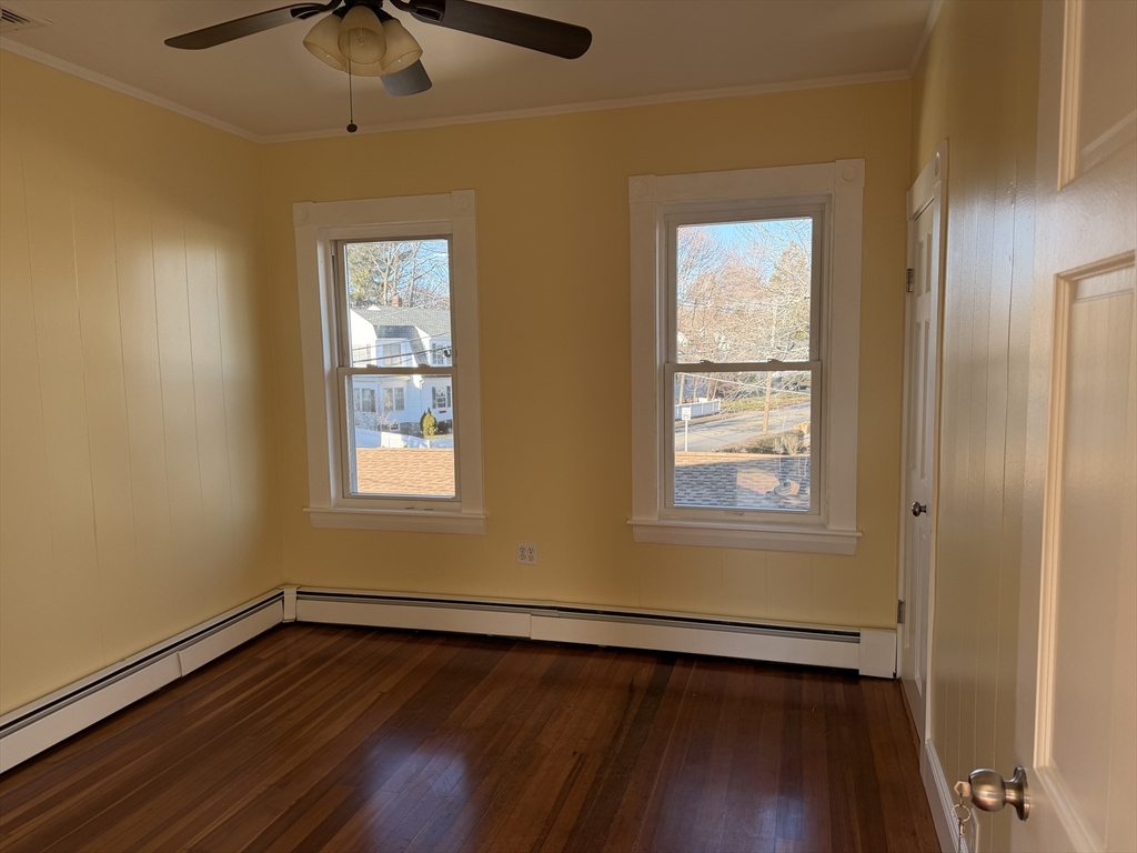 3-5 Milk Street, Unit 2 Methuen, MA 01844 - Photo 5 of 12 a view of an empty room with wooden floor and a window