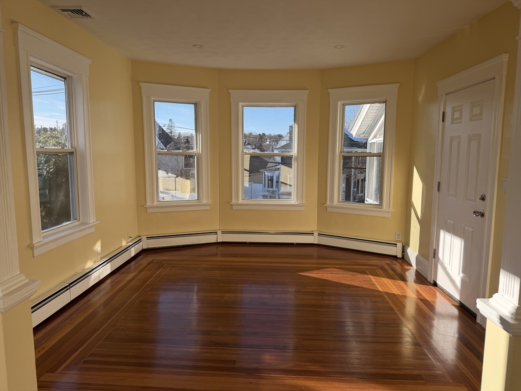 3-5 Milk Street, Unit 2 Methuen, MA 01844 - Photo 7 of 12 a view of an empty room with wooden floor and a window