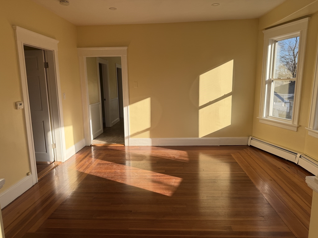 3-5 Milk Street, Unit 2 Methuen, MA 01844 - Photo 8 of 12 a view of an empty room with wooden floor and a window