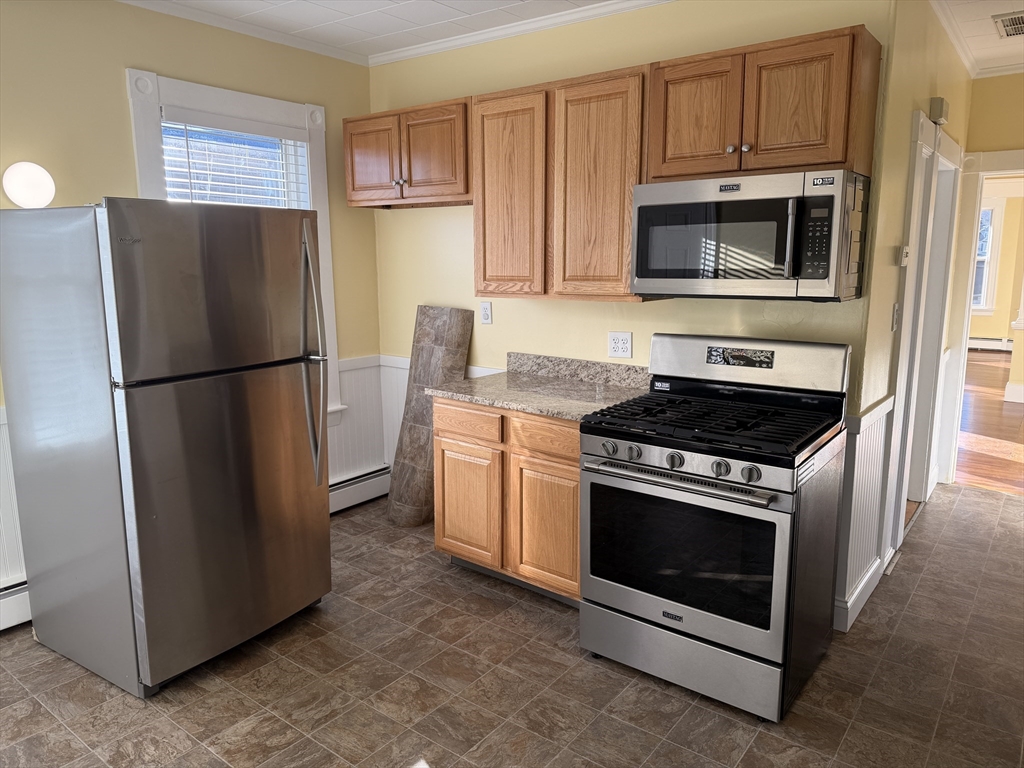 3-5 Milk Street, Unit 2 Methuen, MA 01844 - Photo 9 of 12 a kitchen with a refrigerator stove and microwave