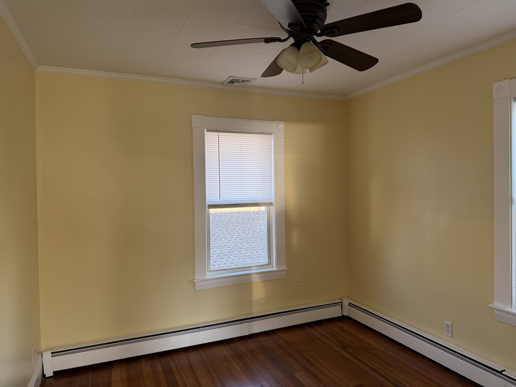 3-5 Milk Street, Unit 2 Methuen, MA 01844 - Photo 10 of 12 a view of empty room with wooden floor and fan