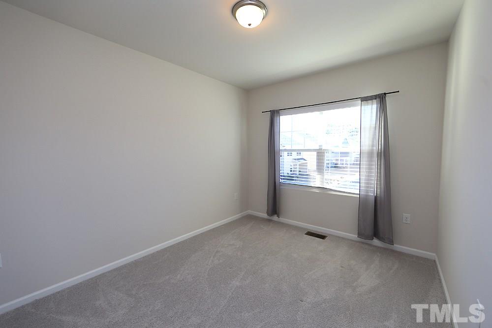 6108 Beale Loop Raleigh, NC 27616 - Photo 11 of 19 an empty room with a window