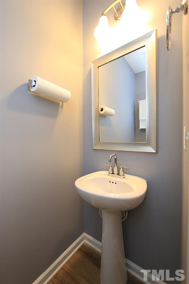 6108 Beale Loop Raleigh, NC 27616 - Photo 7 of 19 a bathroom with a sink a mirror and vanity