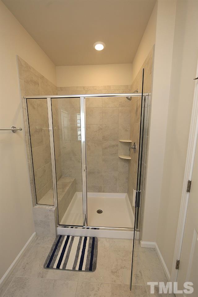 6108 Beale Loop Raleigh, NC 27616 - Photo 10 of 19 a bathroom with a shower and a glass door