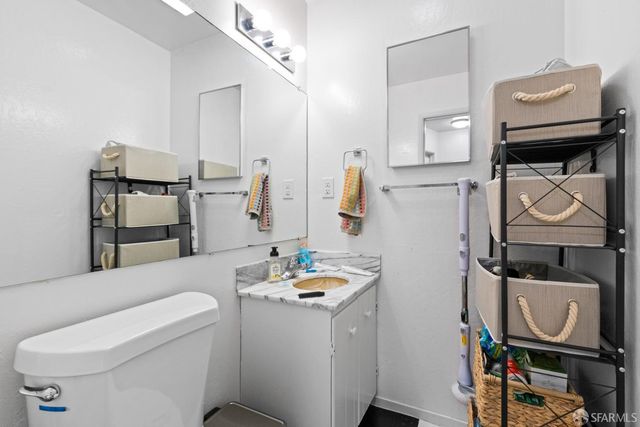 a bathroom with a sink toilet and mirror