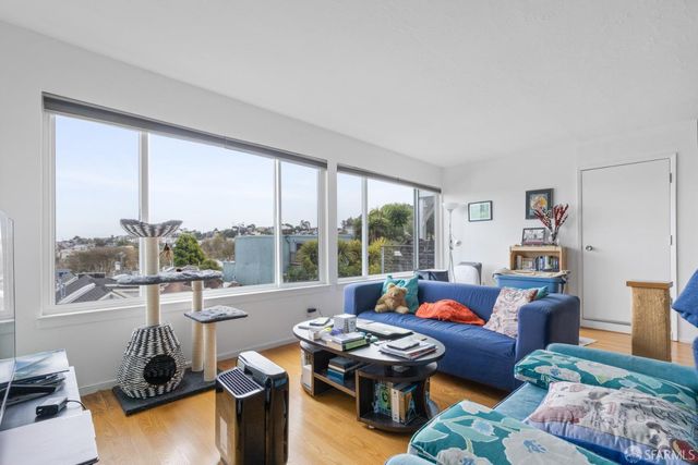 a living room with furniture and a floor to ceiling window
