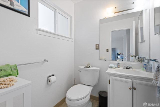 a bathroom with a sink mirror vanity and toilet