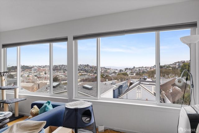 a view of a living room and a floor to ceiling window