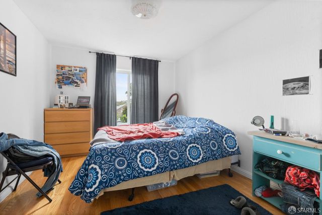 a bedroom with bed and windows