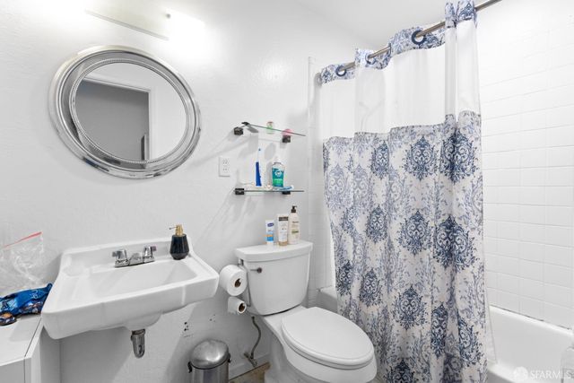 a bathroom with a sink a toilet and a mirror