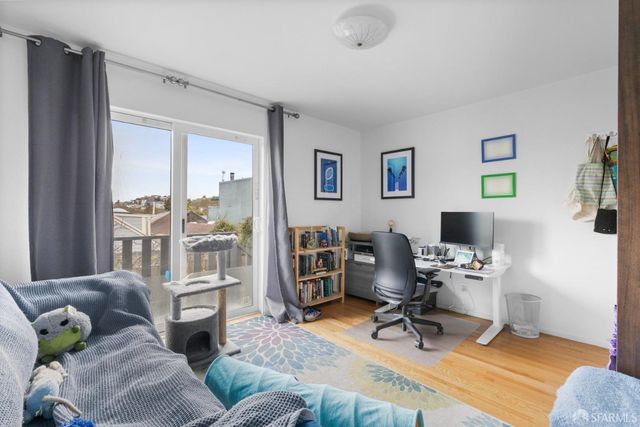 a view of a livingroom with workspace and a couch