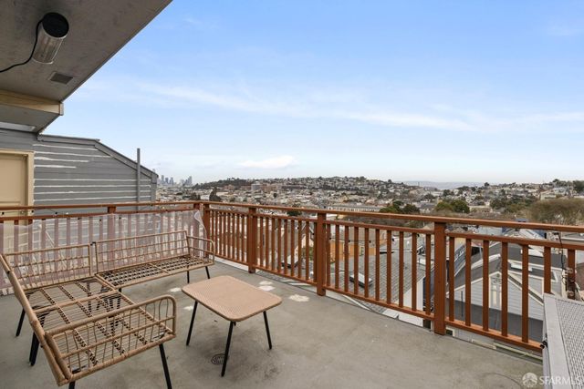a view of a balcony with furniture