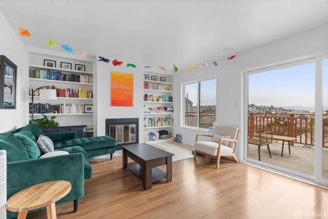 a living room with furniture a rug and a large window