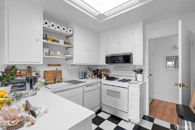 a kitchen with stainless steel appliances a stove a sink and a refrigerator