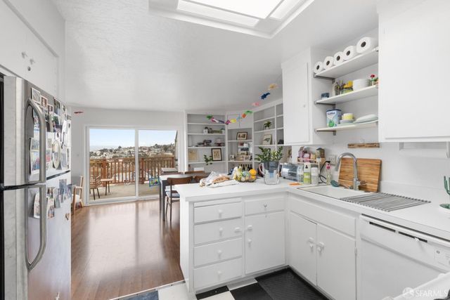 a kitchen with cabinets and window