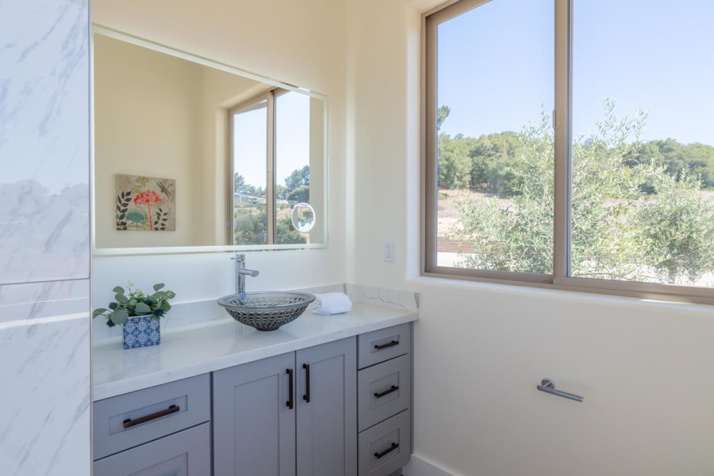 9020 Hidden Canyon Road Salinas, CA 93907 - Photo 36 of 58 a bathroom with a granite countertop sink a large mirror and a window
