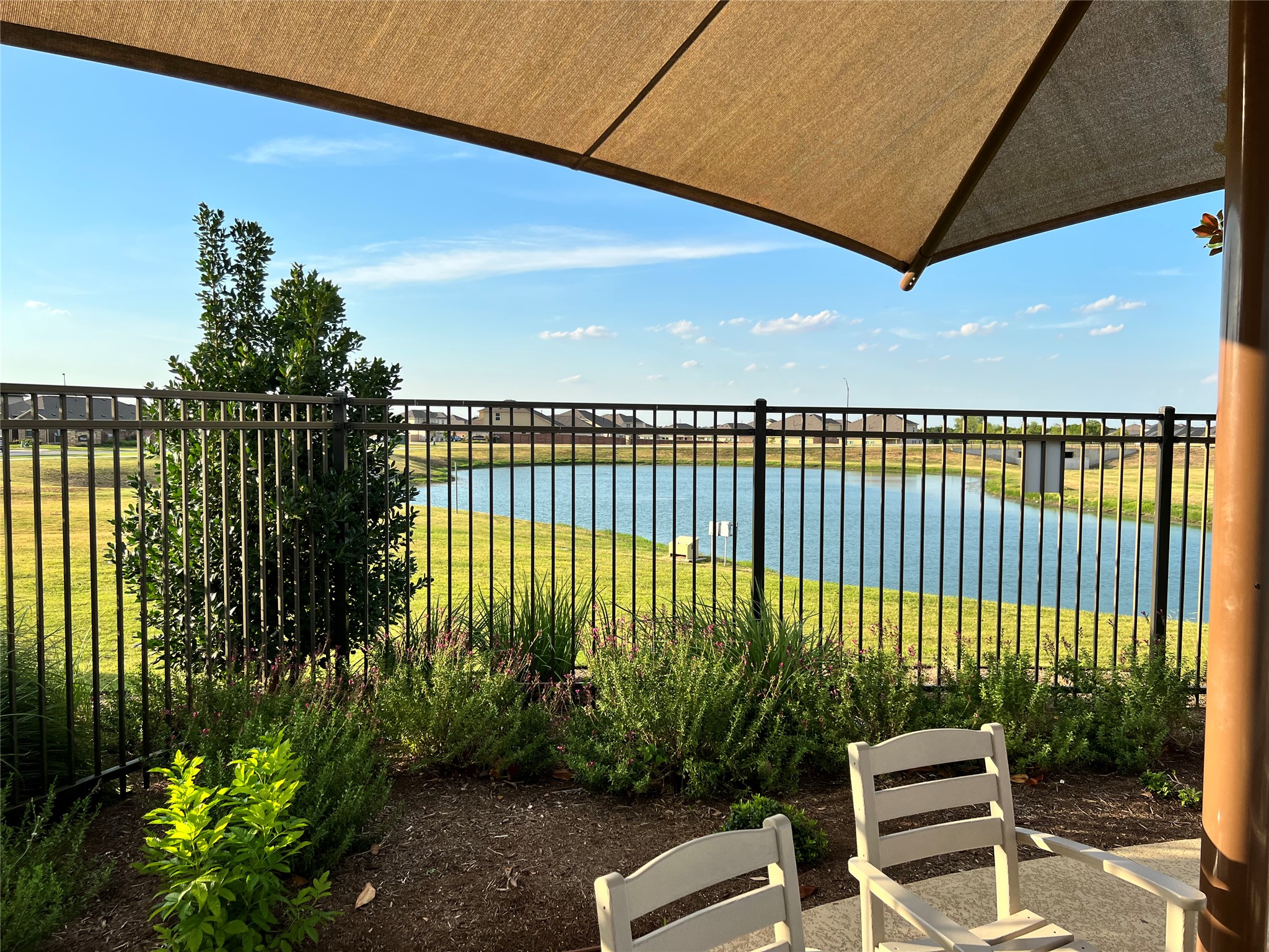 140 Pentro Path Georgetown, TX 78626 - Photo 32 of 37 Enjoy tranquil water views from this private patio, ideal for peaceful outdoor moments.