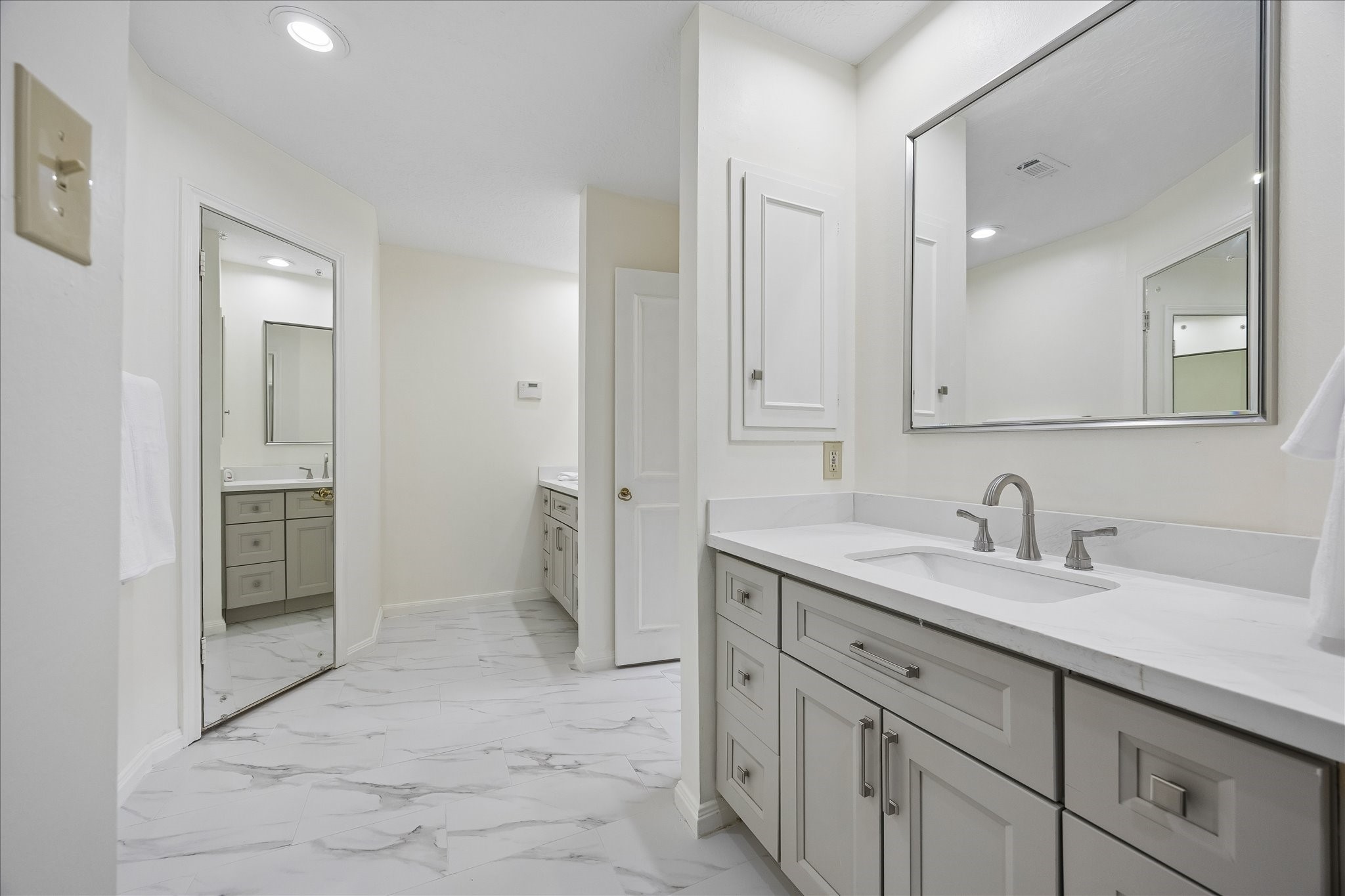 306 Gessner Road Bunker Hill Village, TX 77024 - Photo 23 of 41 Remodeled primary, ensuite bathroom with ceramic tile, double vanities with quartz counter tops and double walk-in closets.
