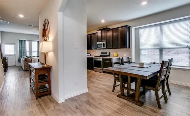 a view of a dining room with furniture window and wooden floor