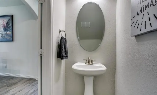 a bathroom with a sink and mirror