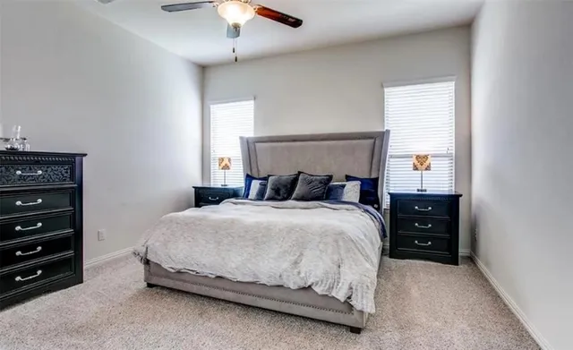 a bedroom with a bed and a ceiling fan