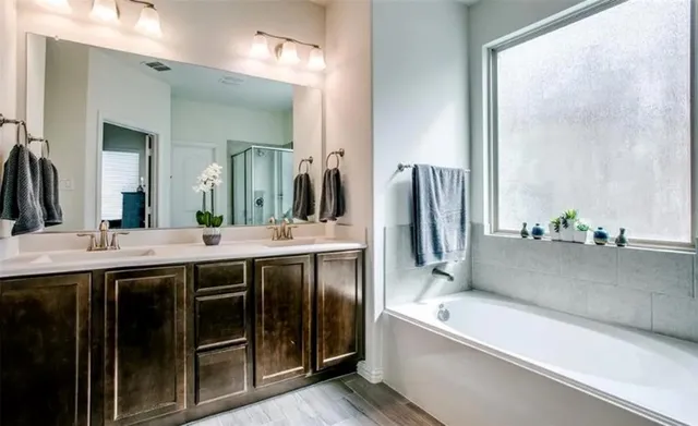 a spacious bathroom with a granite countertop sink and a mirror