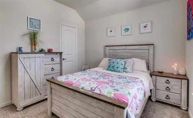 a bedroom with a bed and a dresser