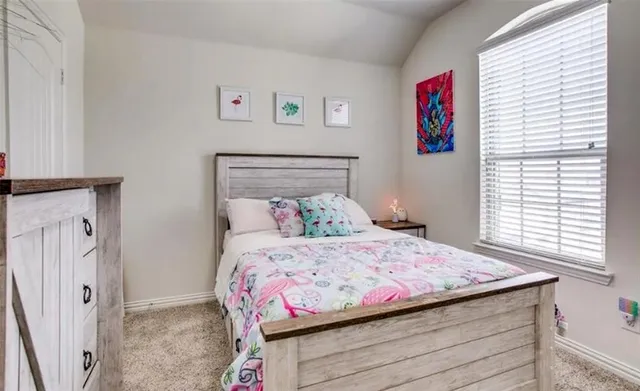 a bedroom with a bed and a window