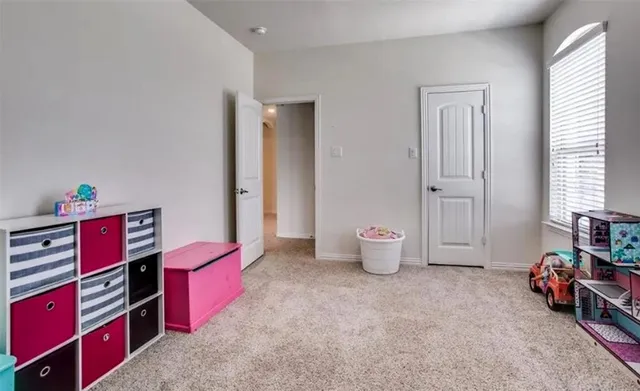 a bedroom with furniture and a book shelf