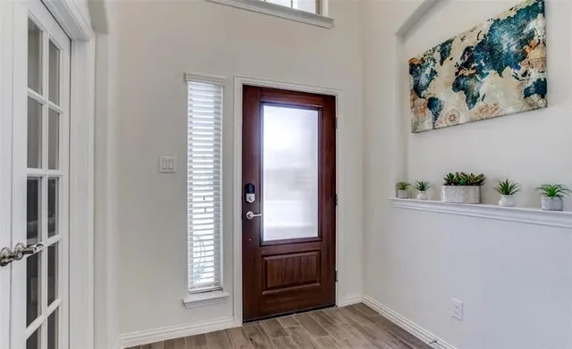 a view of an entryway with wooden floor