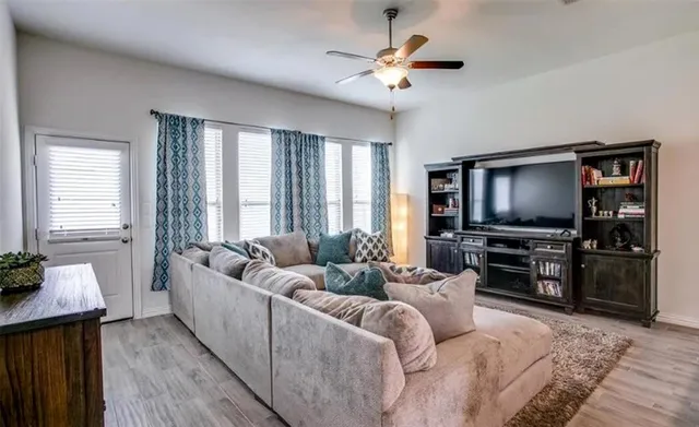 a living room with furniture and a flat screen tv